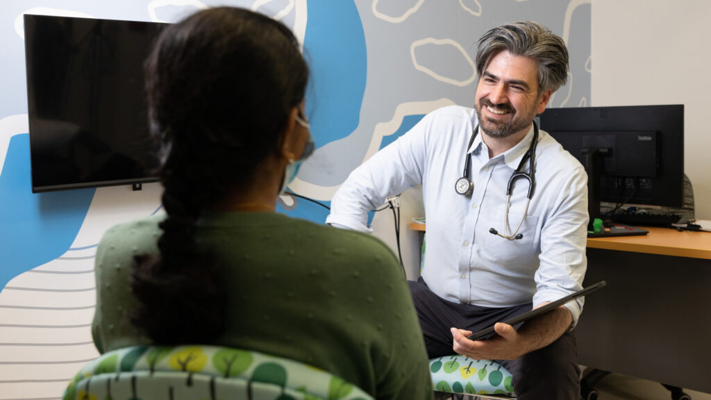 Photo of a healthcare worker smiling at a patient