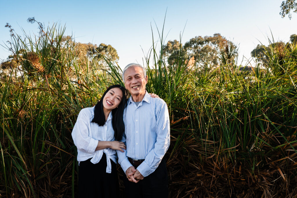 A father and daughter smiling together