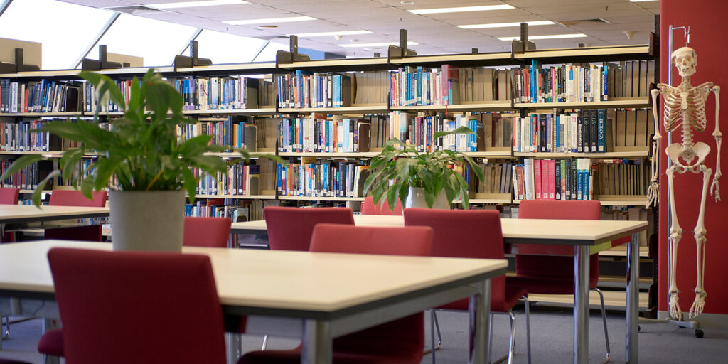 Photo of book shelves and tables at the Monash Health Library