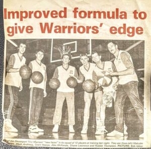 A newspaper clipping from the 1980s of six male basketball players holding balls and looking at the camera on a basketball court.