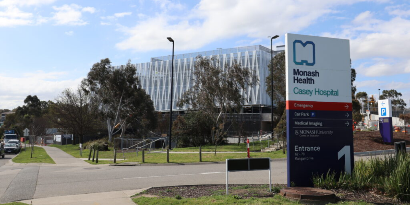 MH wayfinding sign in foreground and car park in background