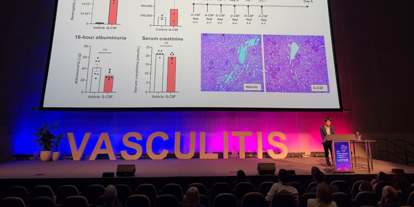 Dr Huan Dang on a stage presenting.