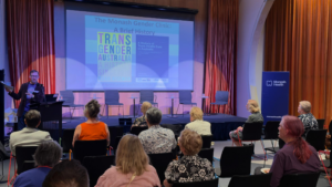 Photo of the stage of a presentation at the Monash Health Gender Clinic 50th Anniversary event